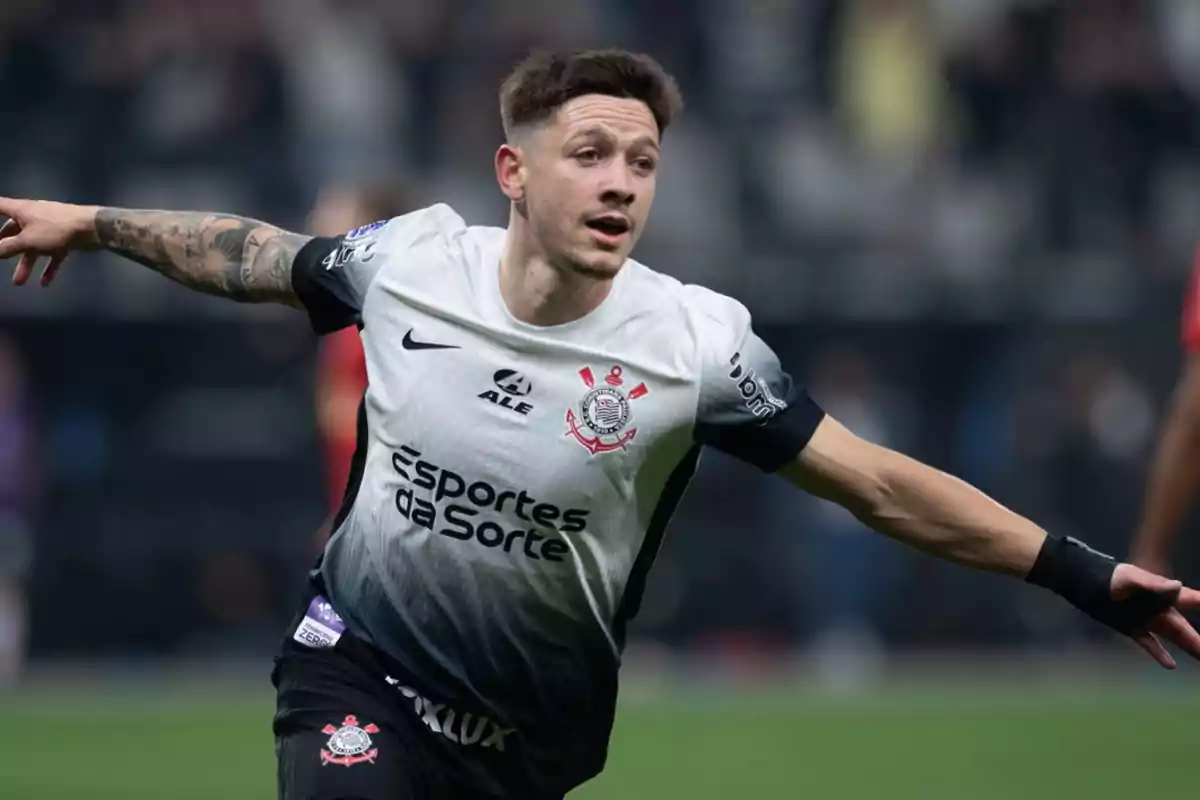 Jugador de fútbol celebrando un gol con los brazos extendidos, vistiendo el uniforme del Corinthians.