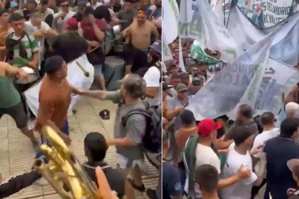 Un grupo de personas se encuentra en una manifestación con banderas y pancartas, algunas personas parecen estar discutiendo o empujándose.