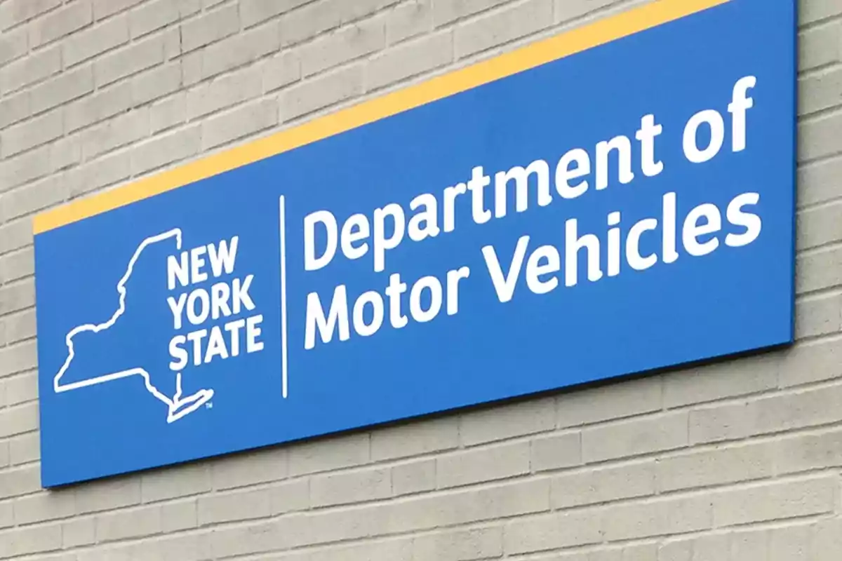 Blue sign of the New York State Department of Motor Vehicles on a brick wall.