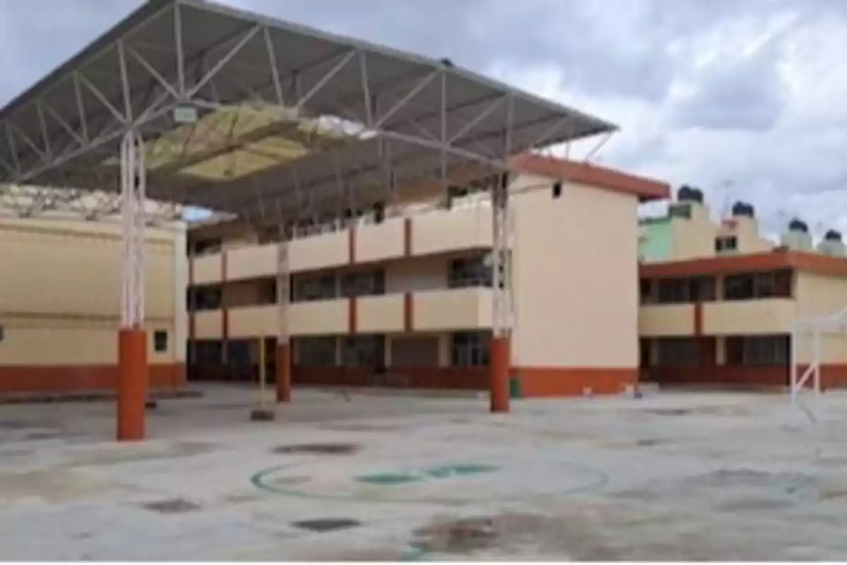 Multi-story school building with a large, covered courtyard.