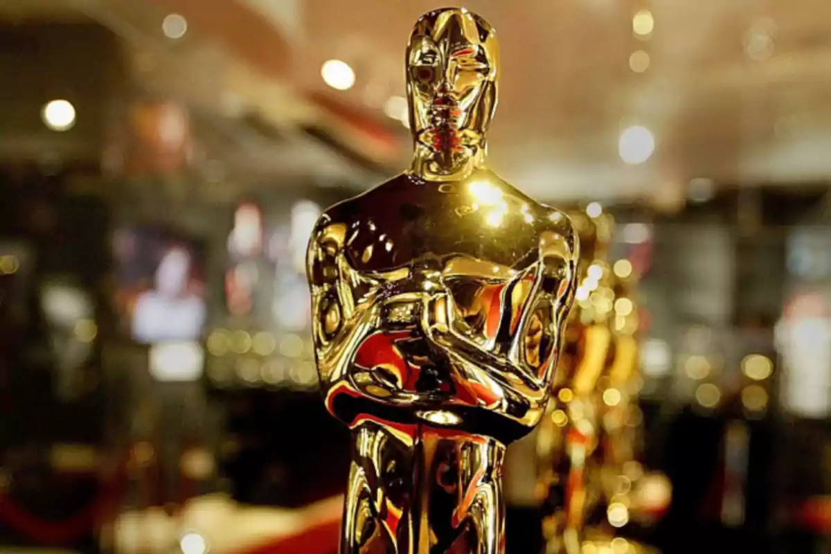 Golden statuette of a film award on a blurred background.