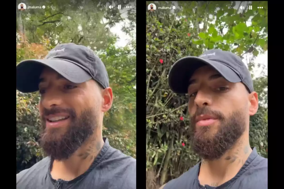 Un hombre con barba y gorra negra está al aire libre rodeado de vegetación.