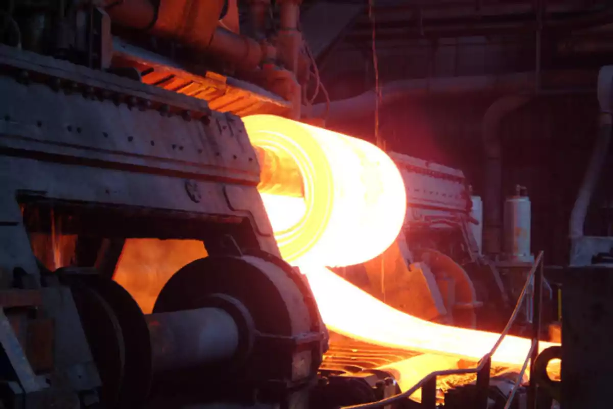 Hot steel rolling process in an industrial plant.