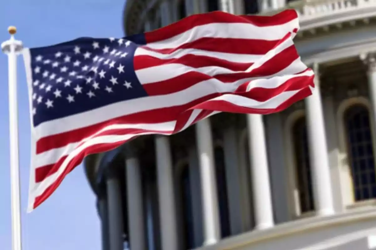 United States flag waving in front of a government building.