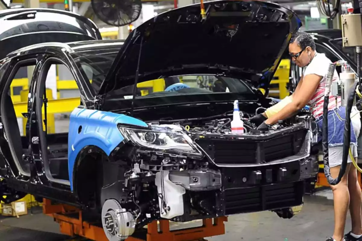 Person working on the assembly line of an automobile factory.