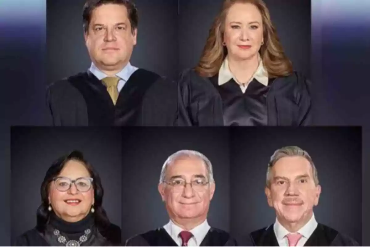 Five people dressed in judicial robes pose for a group photo.