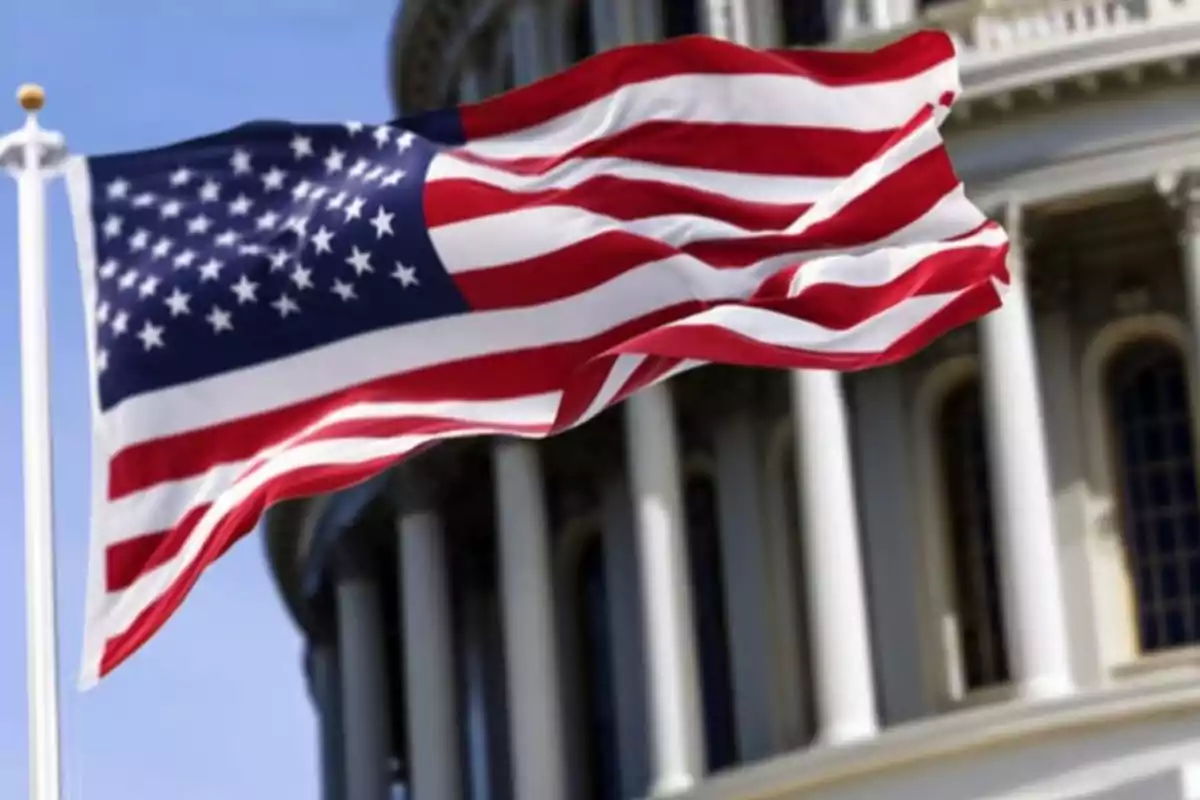 United States flag waving in front of a government building.