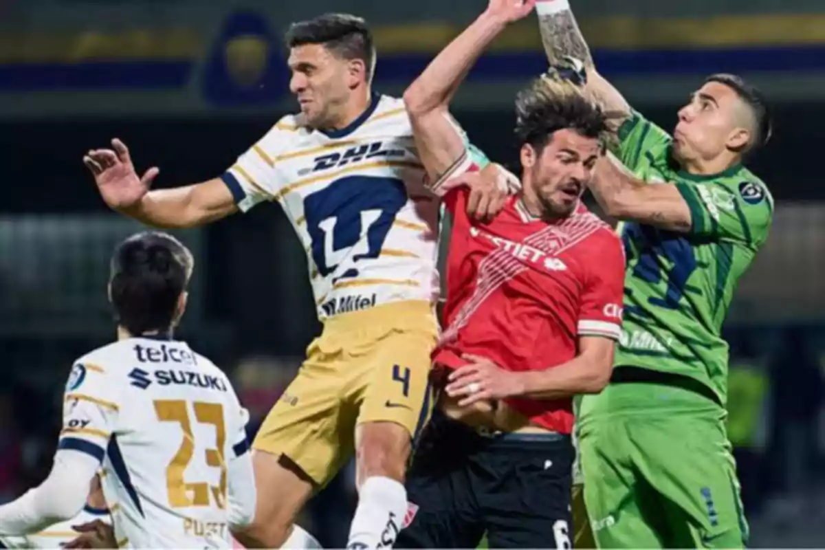 Soccer players compete for the ball in the air during a match.