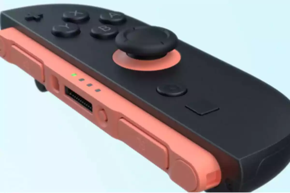 Controlador de videojuego en colores negro y coral con botones visibles y luces indicadoras.