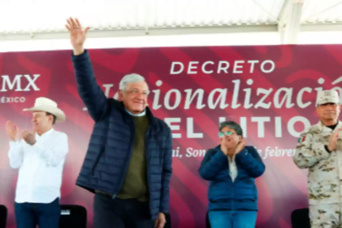 A group of people at a public event with a man raising his hand in front of a sign that says "Nationalization Decree."