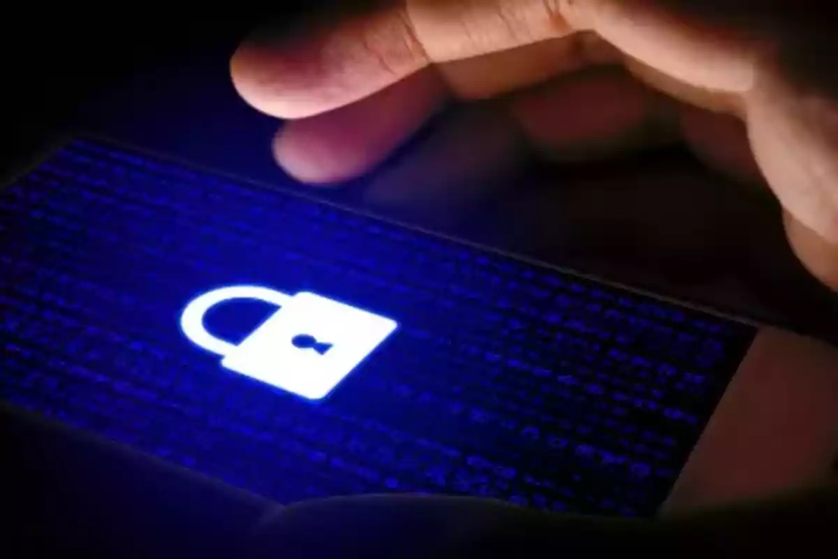 A hand holding a mobile device with a lit lock on the screen, symbolizing digital security.