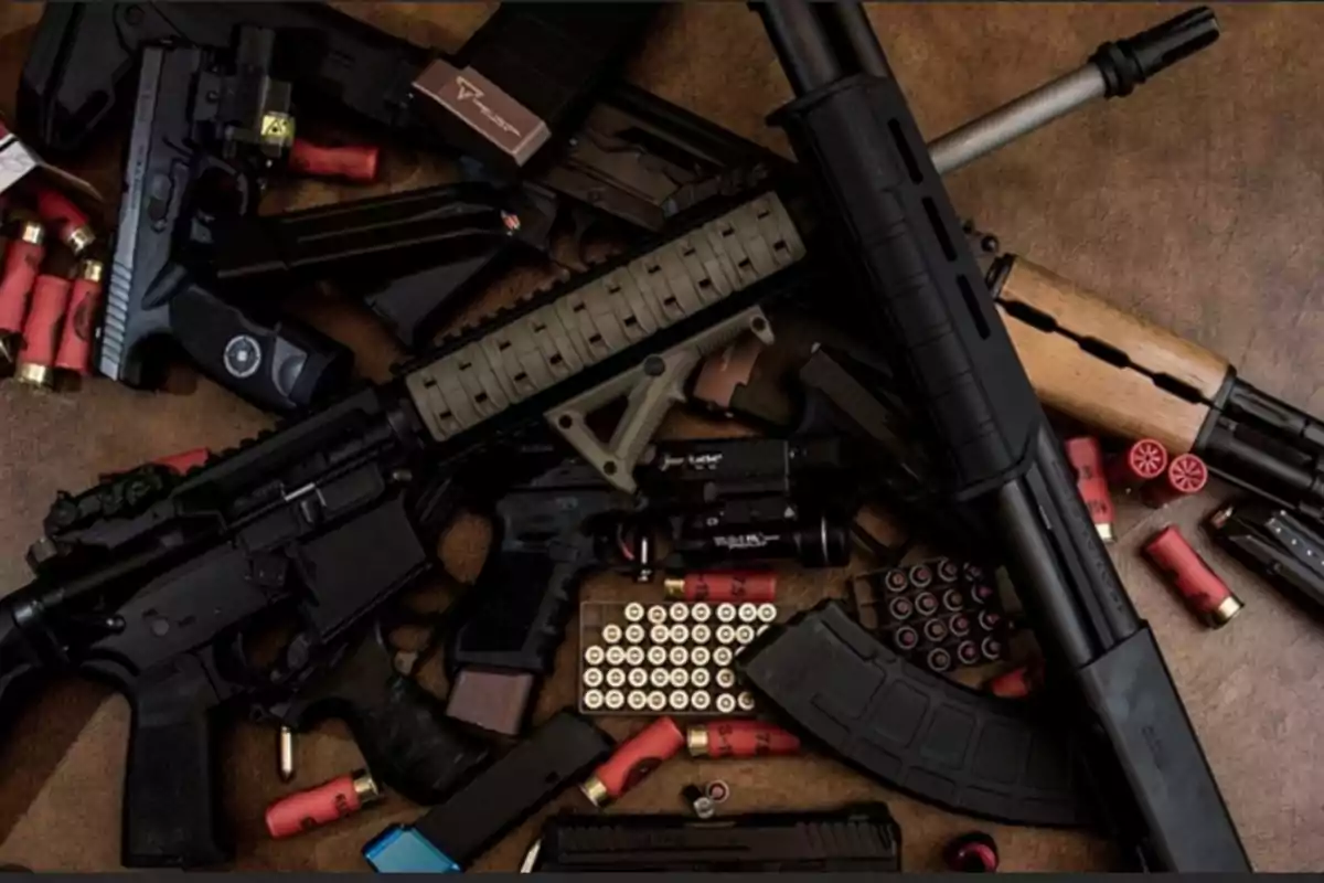 A set of firearms and ammunition on a brown surface.