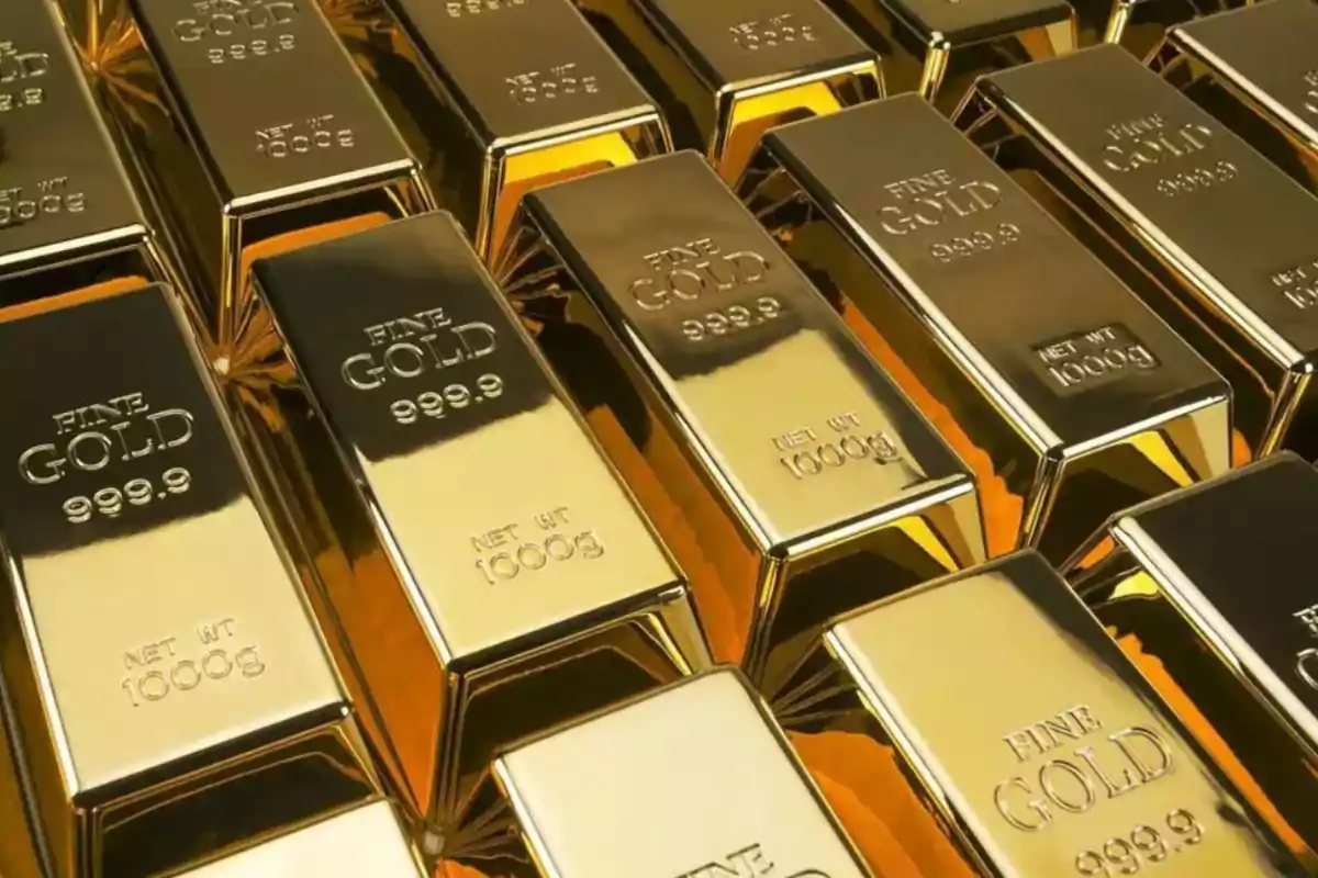 Gold bars stacked with inscriptions of purity and weight.