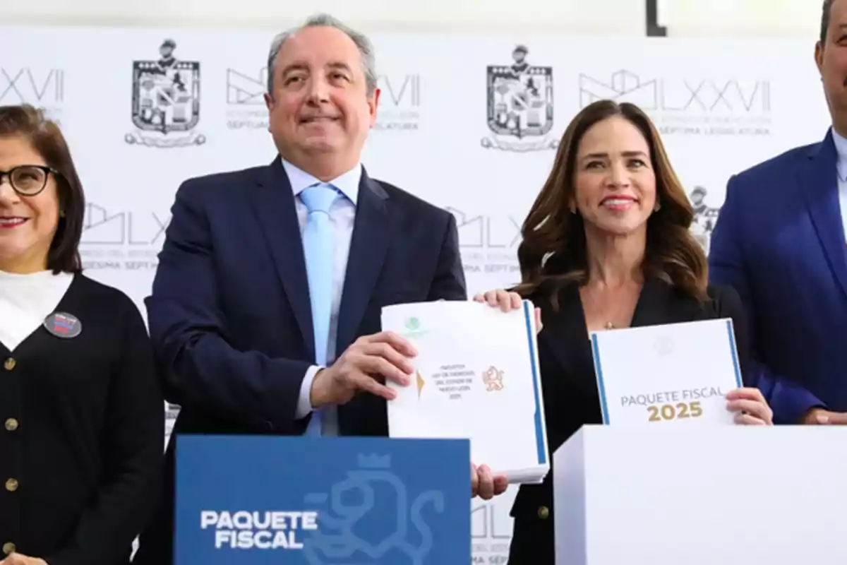 People posing with documents from the "2025 Fiscal Package" at an official event.