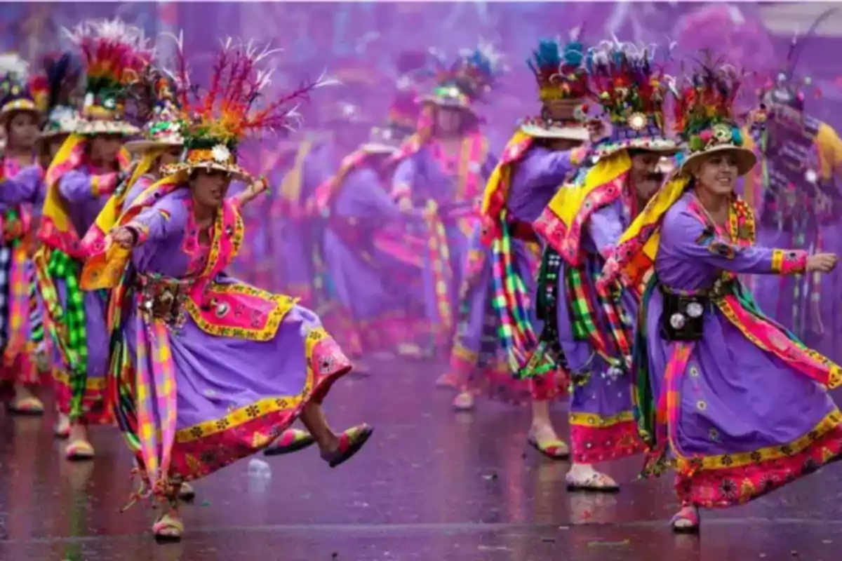 People dressed in colorful traditional costumes dancing at a cultural festival.