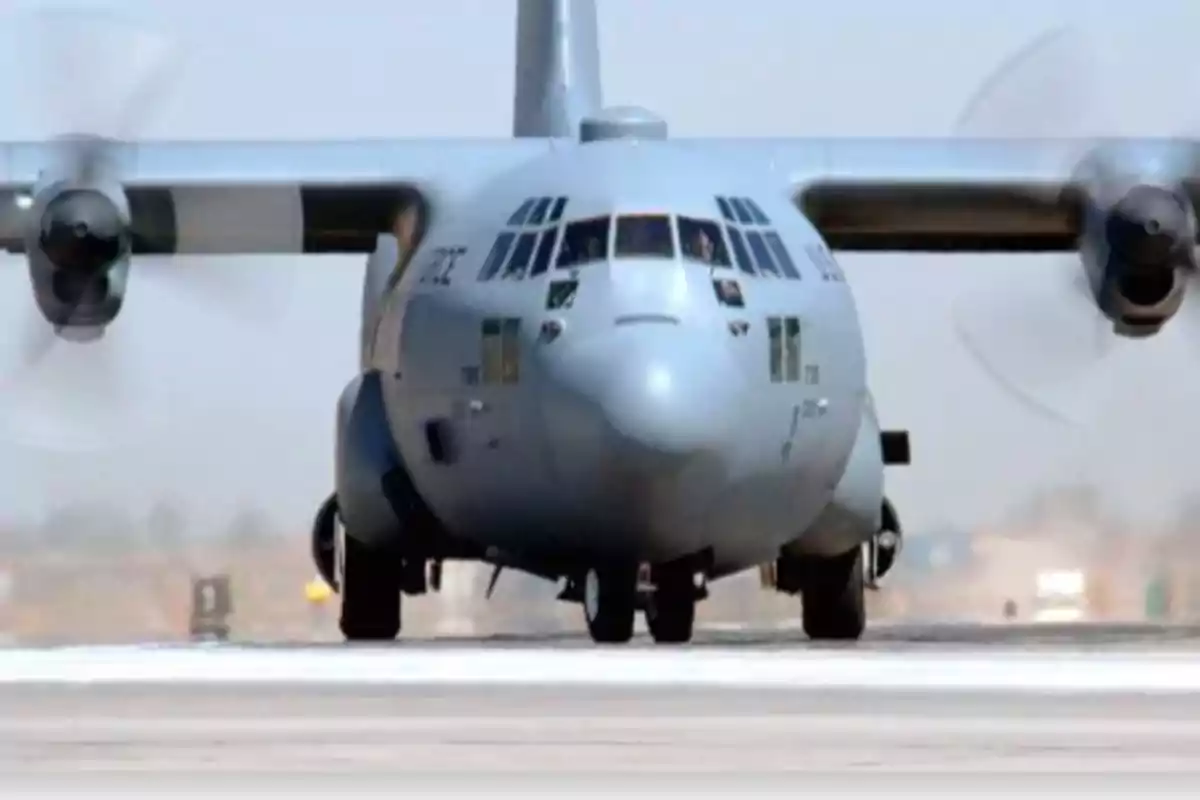 Military cargo plane taking off from a runway.