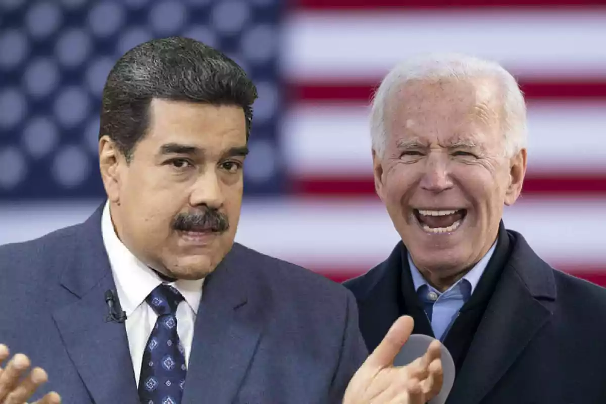 Dos hombres en traje frente a una bandera de Estados Unidos.